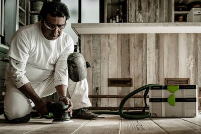 Tradesman sanding floor