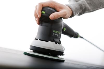 A man sands a surface